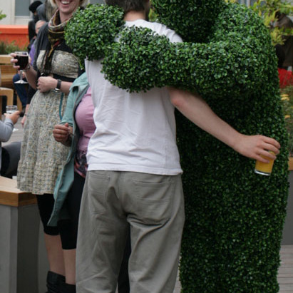 A Hedge Man giving a hug at an event in London